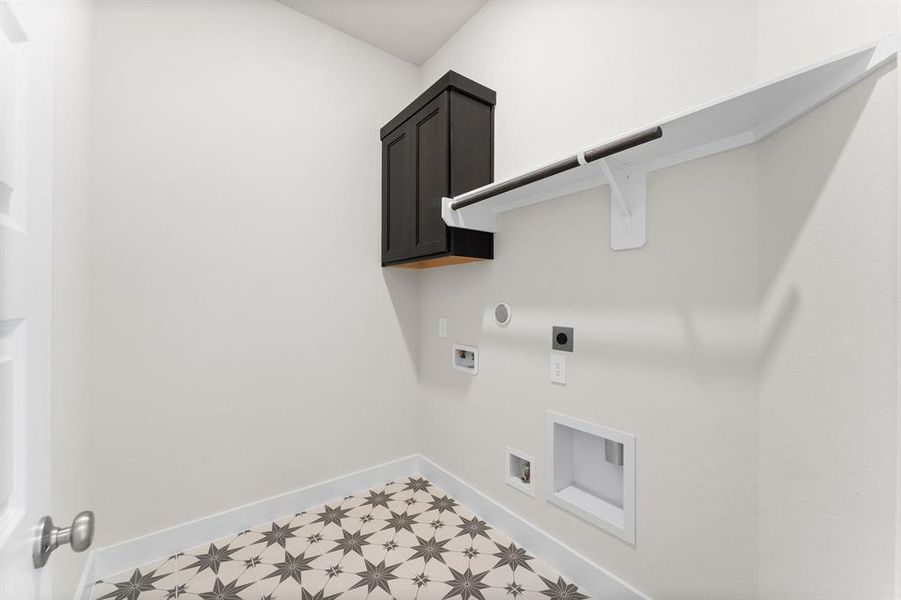 Utility Room with Washer and Dryer Connections, Hanging Bar, and Storage Cabinet.