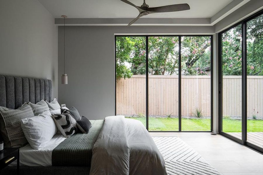 Loads of natural light in the primary bedroom with views to the stunning backyard. Hard wired for automated shades that hide away in the coves of the ceiling.