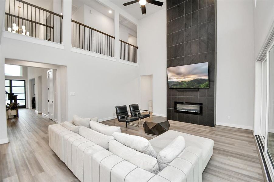 Large family room with a modern fire place and recently upgraded black tiles wall gives a warn welcoming feelings.