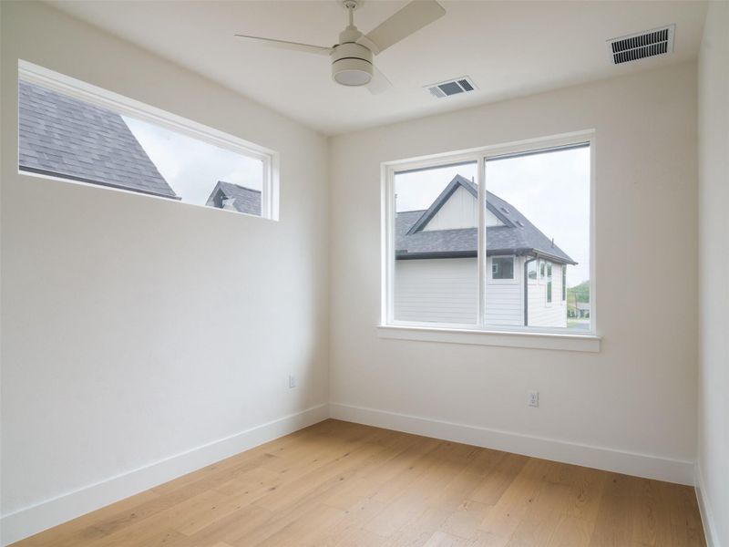 Interior room featuring light wood-finish flooring, white walls, and white trim