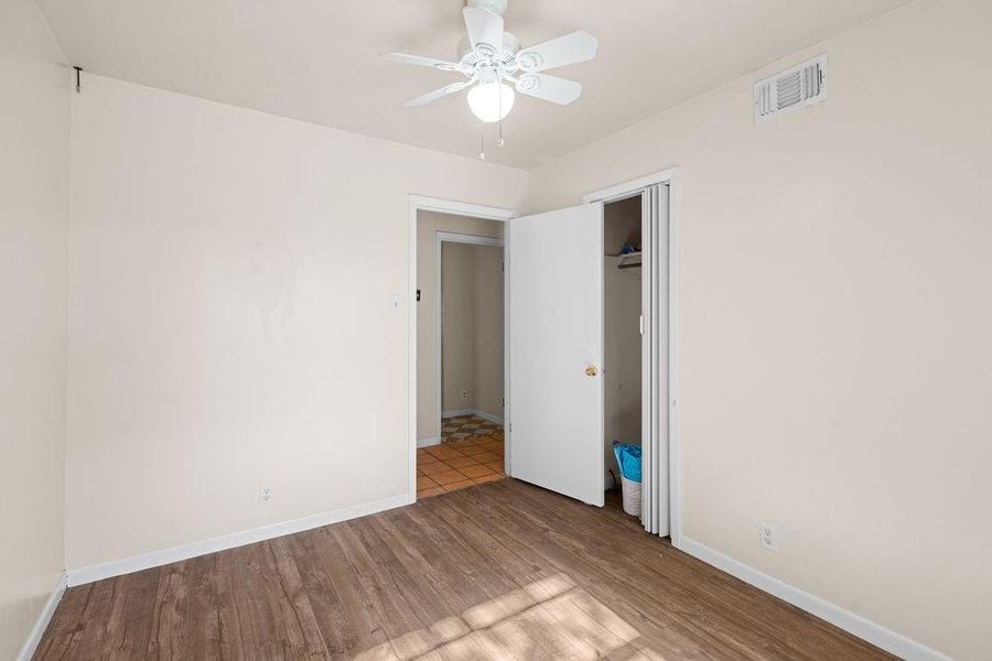 Bedroom featuring wood finished floors, a ceiling fan, and a closet