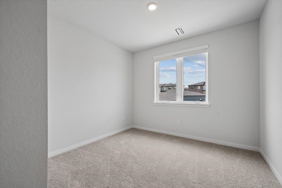 A room with a window and carpet. A room with a window and carpet.