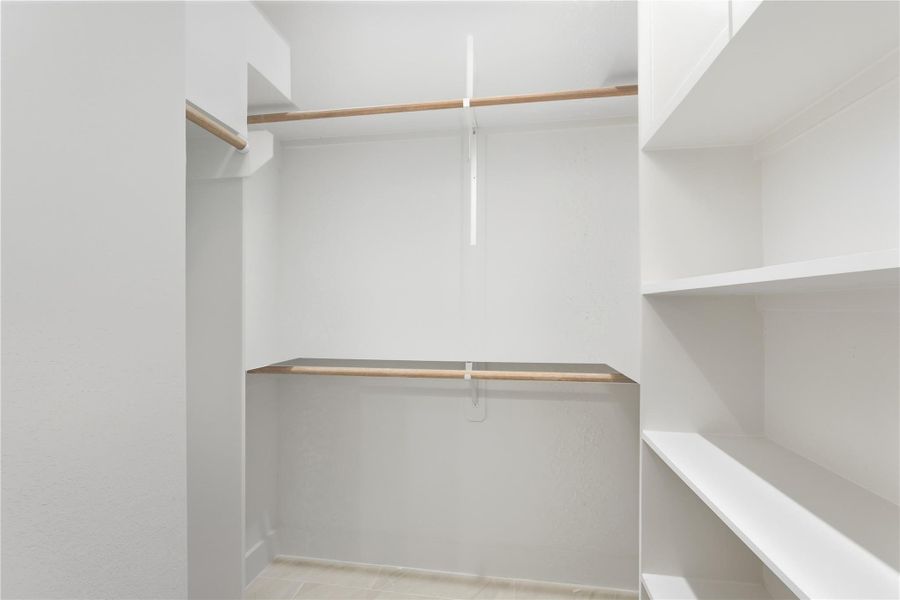 The primary suite features a spacious walk-in closet designed to keep everything organized and within easy reach. With built-in shelving and double hanging rods, there’s plenty of room for clothing, shoes, and accessories. It’s a functional space that makes everyday living feel a little more effortless. The primary suite features a spacious walk-in closet designed to keep everything organized and within easy reach. With built-in shelving and double hanging rods, there’s plenty of room for clothing, shoes, and accessories. It’s a functional space that makes everyday living feel a little more effortless.