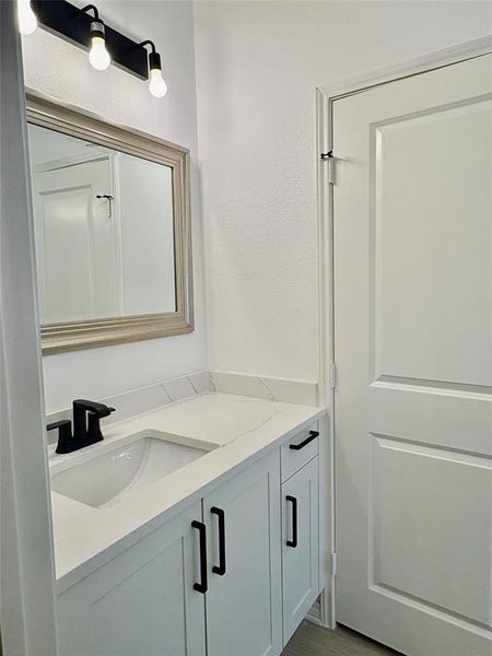 Bathroom with vanity and dark wood finished floors