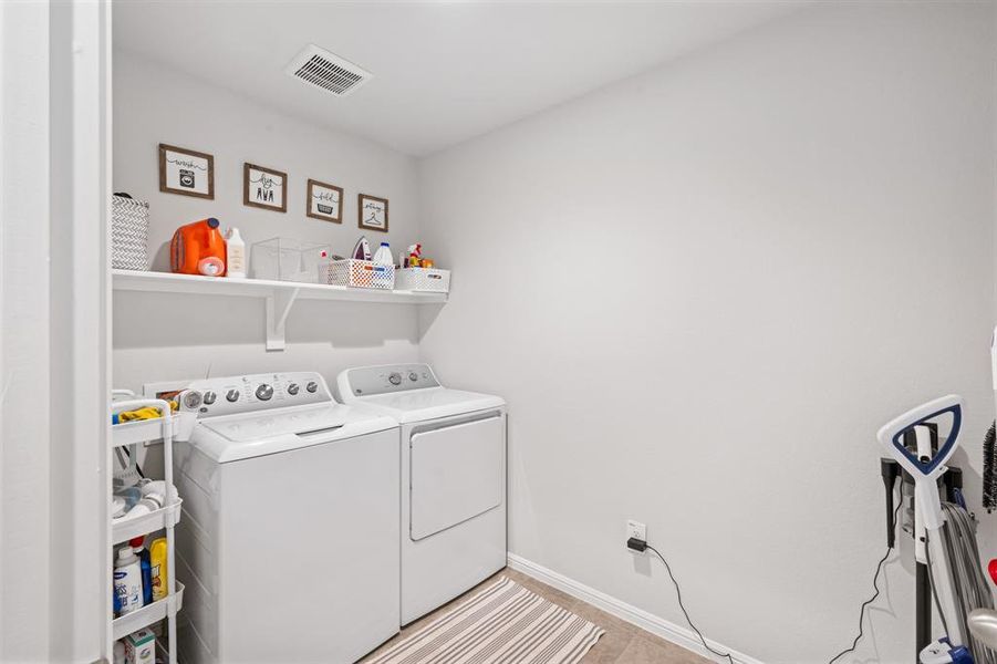 Laundry area with washer and clothes dryer and baseboards