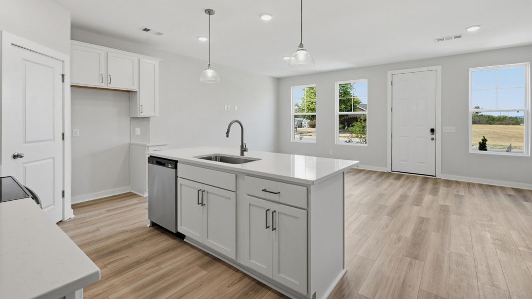 White kitchen island with sink and dishwasher
