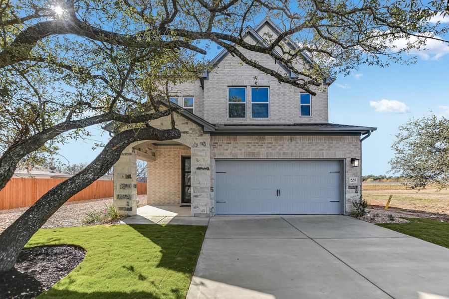 Front exterior of a new home in South Brook, Leander, TX, highlighting curb appeal (Image 1). Front exterior of a new home in South Brook, Leander, TX, highlighting curb appeal (Image 1).