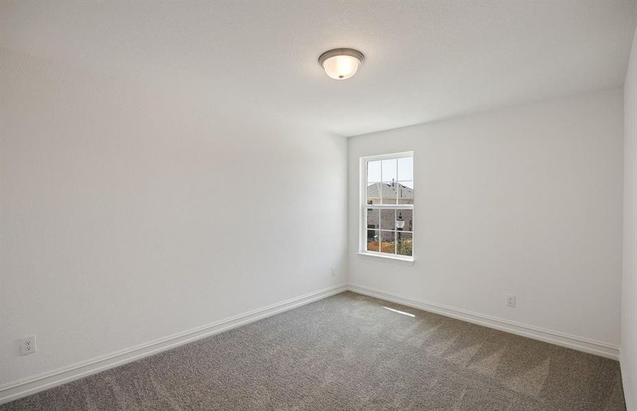 Spacious secondary bedroom with large window *real home pictured