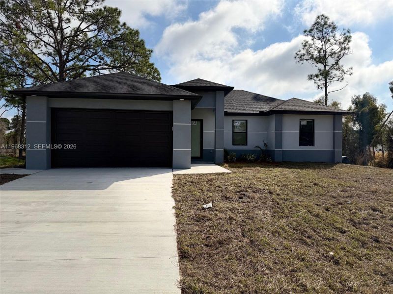 Front exterior of a new home in , Lehigh Acres, FL, highlighting curb appeal (Image 3).