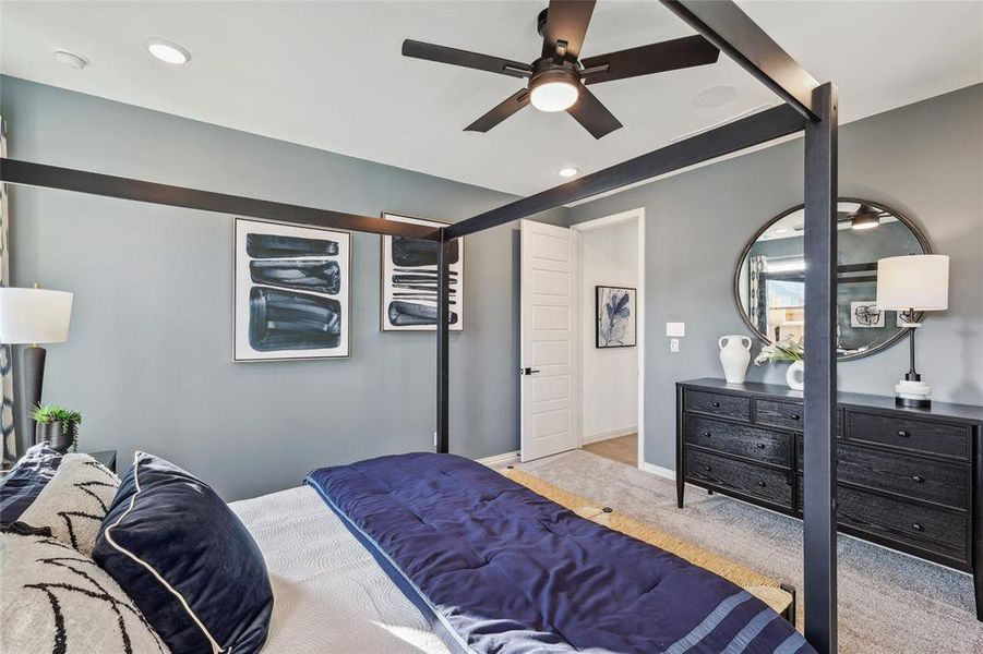 Carpeted bedroom with ceiling fan