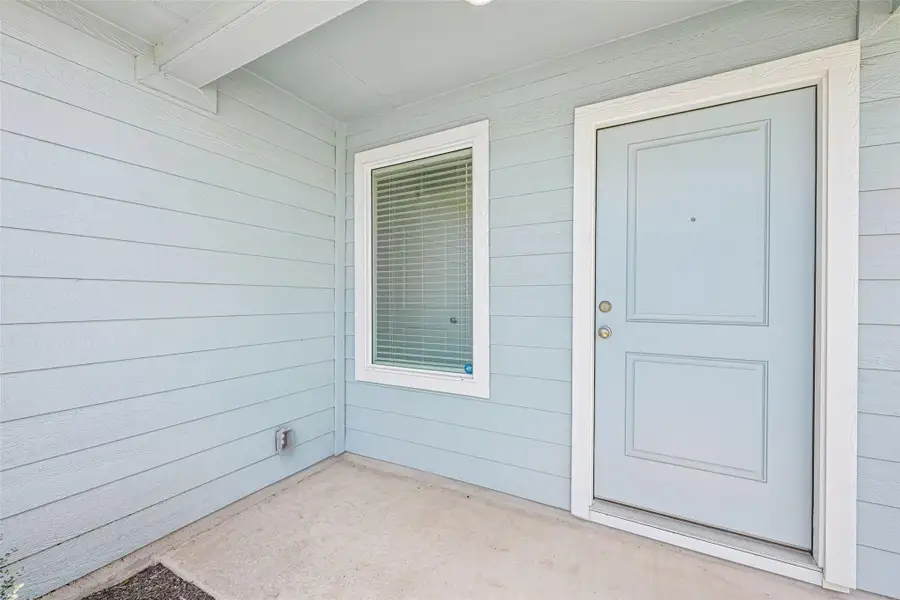 Entryway featuring horizontal siding and a light blue paneled door with white trim Entryway featuring horizontal siding and a light blue paneled door with white trim