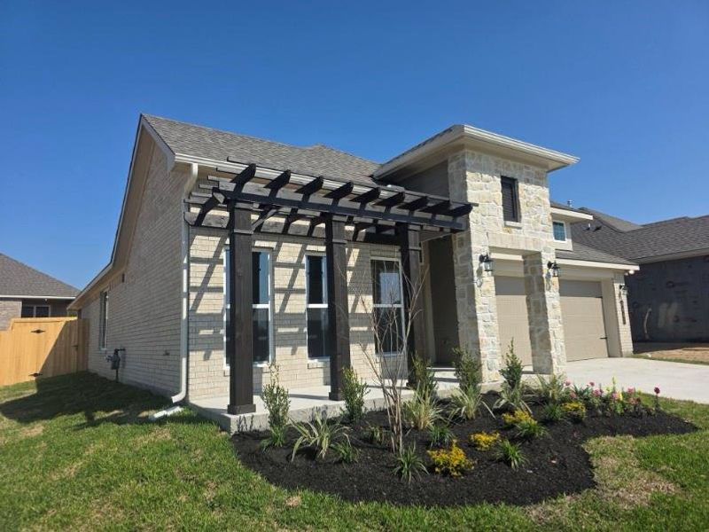 Front exterior of a new home in , Brenham, TX, highlighting curb appeal (Image 14).