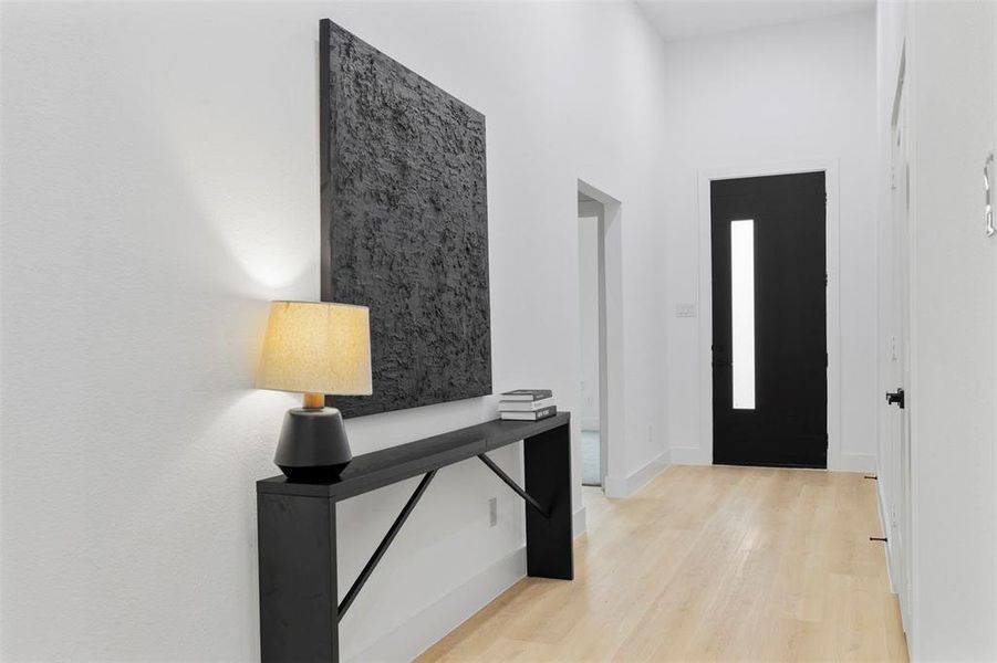 Entrance foyer with light wood-type flooring and baseboards