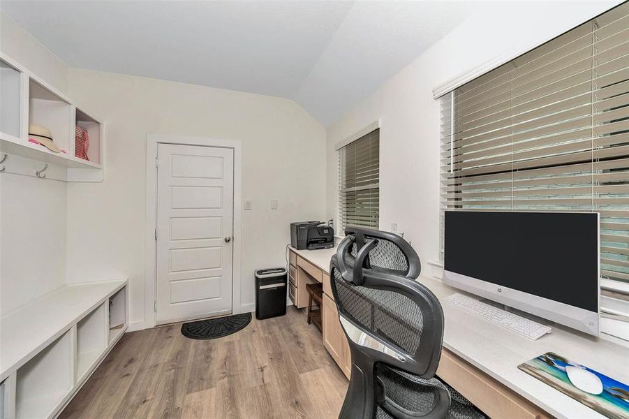 Office featuring vaulted ceiling and light hardwood / wood-style floors