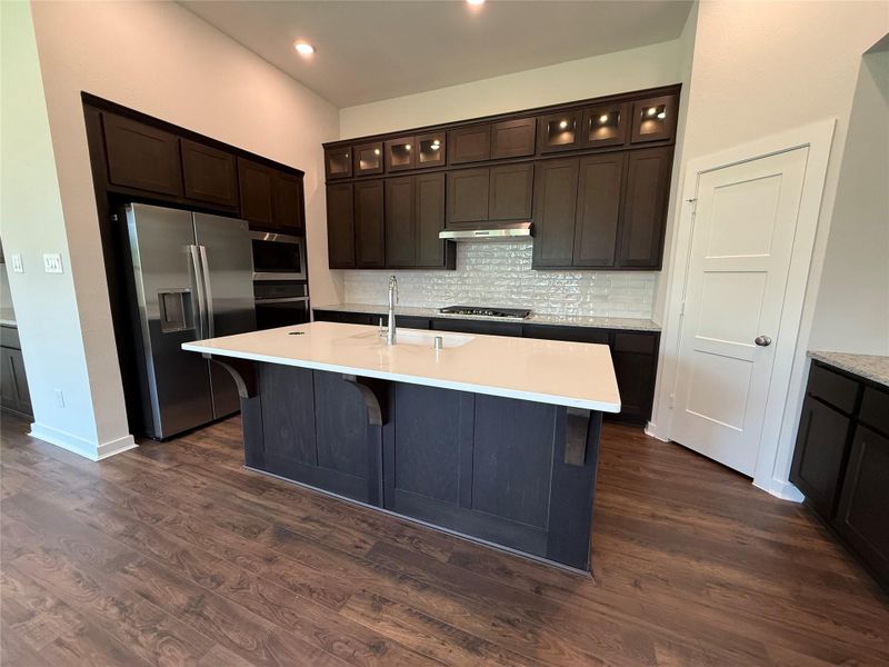 Timeless kitchen featuring quartz countertops, upgraded composite sink, pots and pans drawers and more!