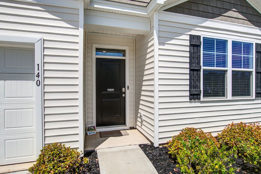 Exterior details and patio area of a home in Pine Hills at Cane Bay, Summerville (Image 3).