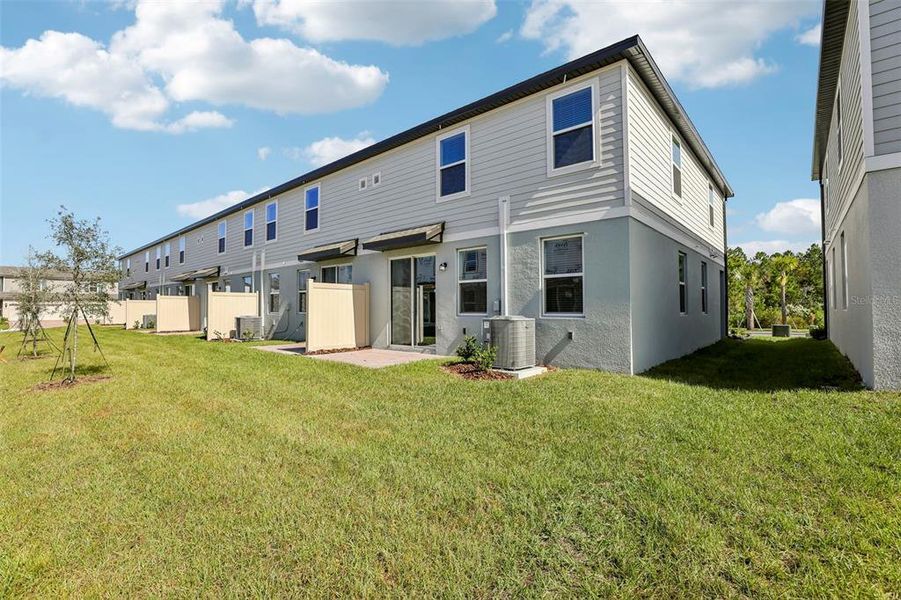 Exterior details and patio area of a home in The Meadow at Crossprairie Townes, St. Cloud (Image 25).