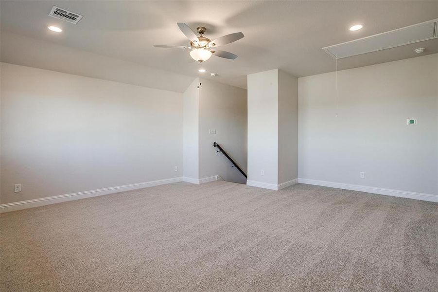 Spare room with ceiling fan and light colored carpet