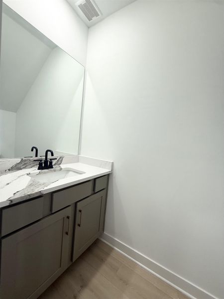 Bathroom featuring vanity and light wood-style flooring
