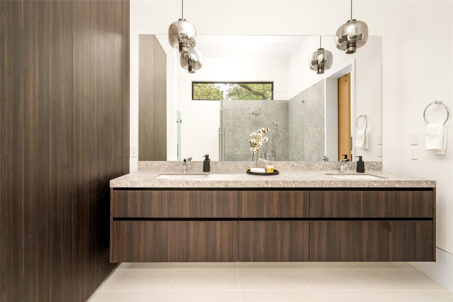 Beautifully designed bath with a floating dual vanity, rich wood tones, and sleek, contemporary detailing.