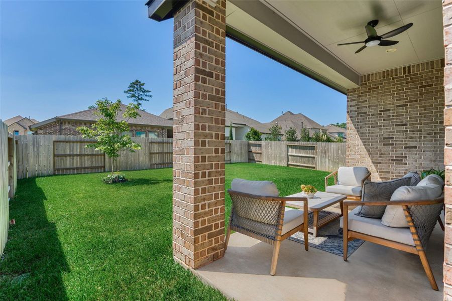Private backyard - with only single homes around - allows full enjoyment of this large grassy yard, covered porch and upgraded fan.