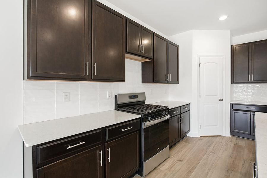 A kitchen with black cabinets. A kitchen with black cabinets.