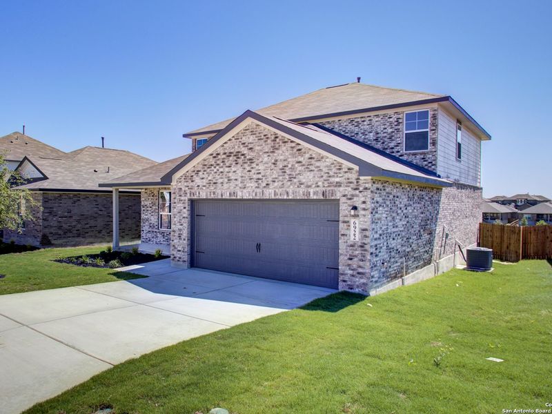 Front exterior of a new home in Comanche Ridge, San Antonio, TX, highlighting curb appeal (Image 2).