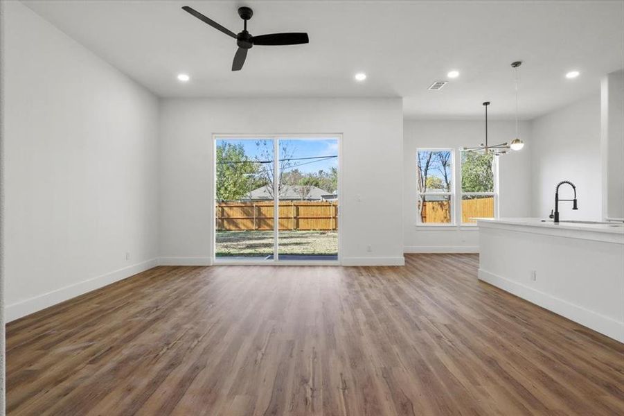 Unfurnished living room featuring recessed lighting, dark wood finished floors, and a ceiling fan