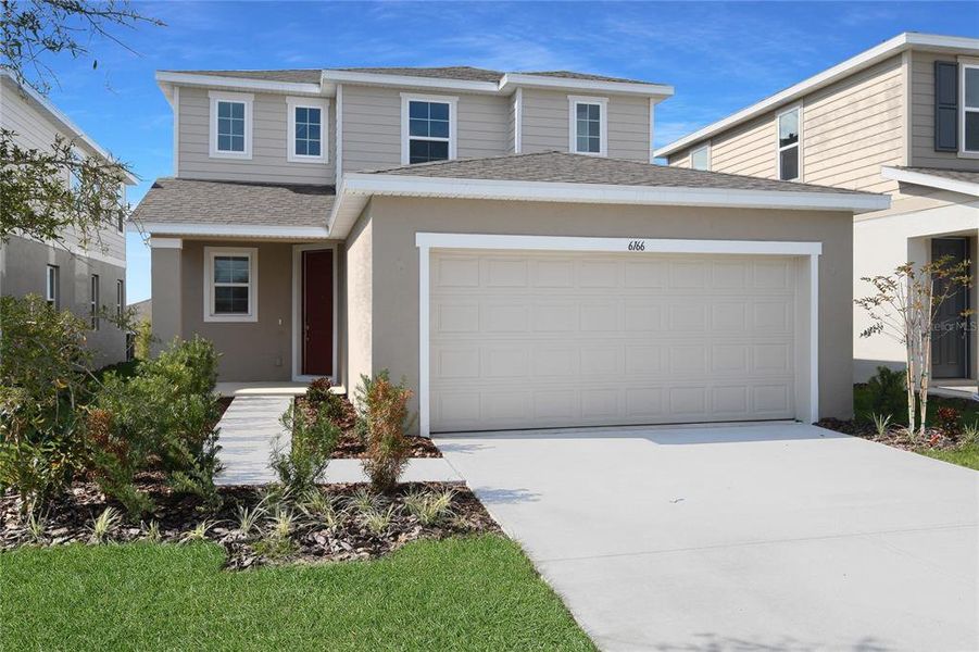 Front exterior of a new home in Seasons at Scenic Terrace, Lake Hamilton, FL, highlighting curb appeal (Image 1). Front exterior of a new home in Seasons at Scenic Terrace, Lake Hamilton, FL, highlighting curb appeal (Image 1).