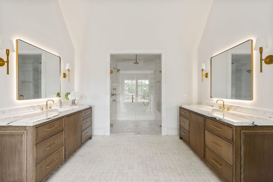 Primary bath featuring back lit mirrors, oversized shower, rift cut white oak cabinetry, and marble tiles. Primary bath featuring back lit mirrors, oversized shower, rift cut white oak cabinetry, and marble tiles.