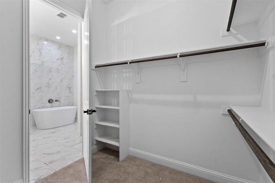Spacious closet with marble finish floors Spacious closet with marble finish floors