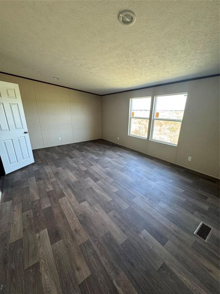 Textured ceilings and wide plank flooring define this versatile interior space.