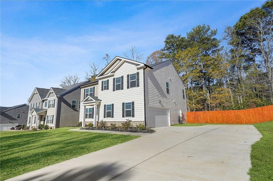 Front exterior of a new home in The Greens at Thompson Creek, Hampton, GA, highlighting curb appeal (Image 25).