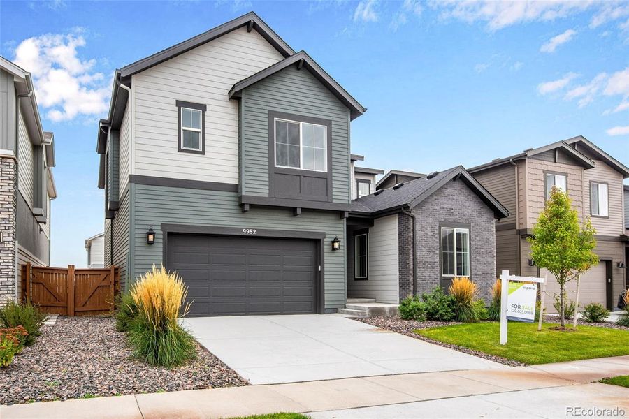 Front exterior of a new home in Reunion Ridge, Commerce City, CO, highlighting curb appeal (Image 1).