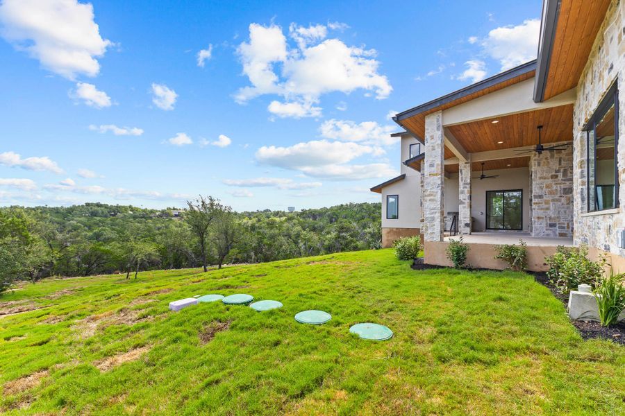 Perched on a verdant hillside, this residence showcases a covered patio perfect for al fresco living amidst natural beauty. Perched on a verdant hillside, this residence showcases a covered patio perfect for al fresco living amidst natural beauty.