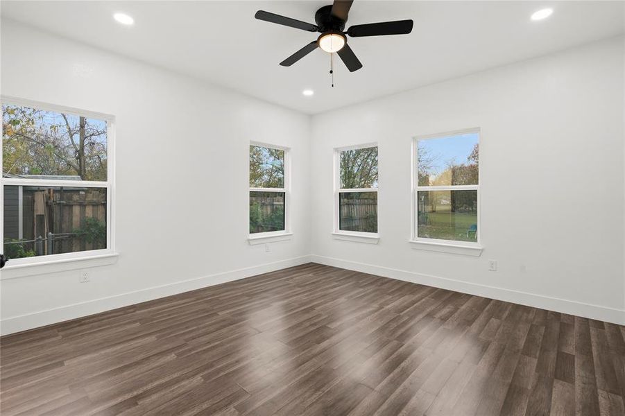 Unfurnished room with ceiling fan and dark hardwood / wood-style floors