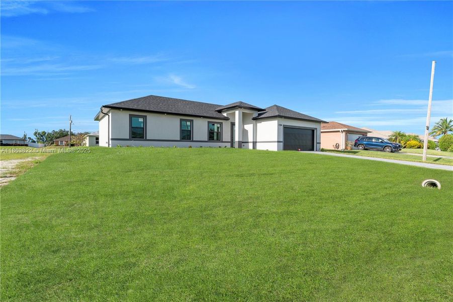 Front exterior of a new home in , Cape Coral, FL, highlighting curb appeal (Image 20). Front exterior of a new home in , Cape Coral, FL, highlighting curb appeal (Image 20).