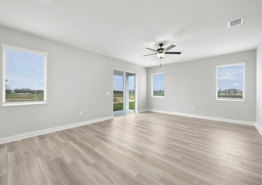 The family room flows seamlessly to the covered back patio by sliding glass doors