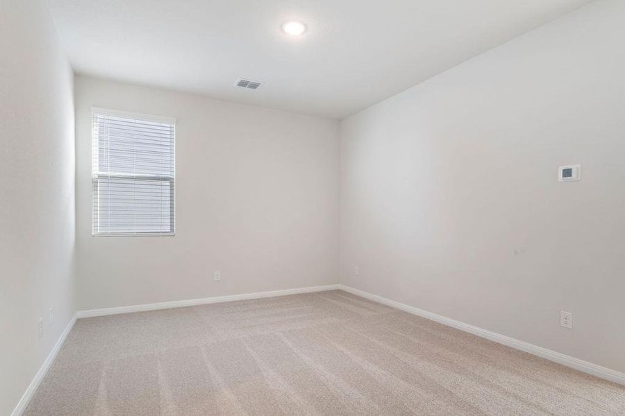 Unfurnished room with light carpet and baseboards