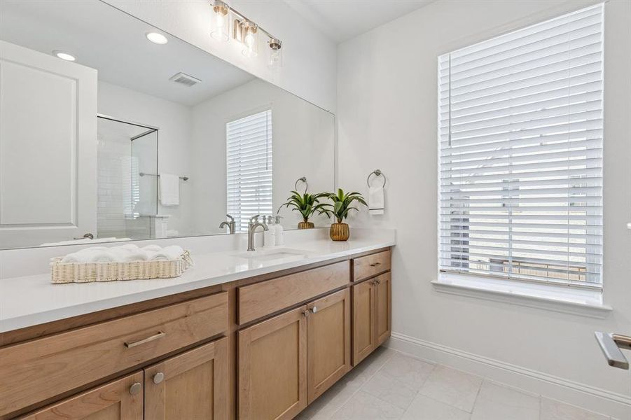 Bathroom with vanity, a stall shower, recessed lighting, and light tile patterned floors