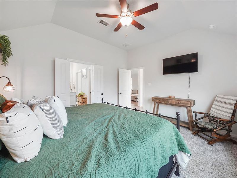 High ceilings embellish this primary bedroom but wait until you see the en suite!