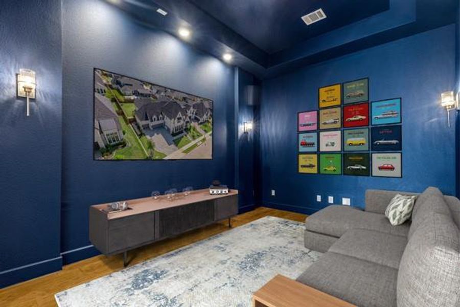 Home theater with wood finished floors and a tray ceiling Home theater with wood finished floors and a tray ceiling
