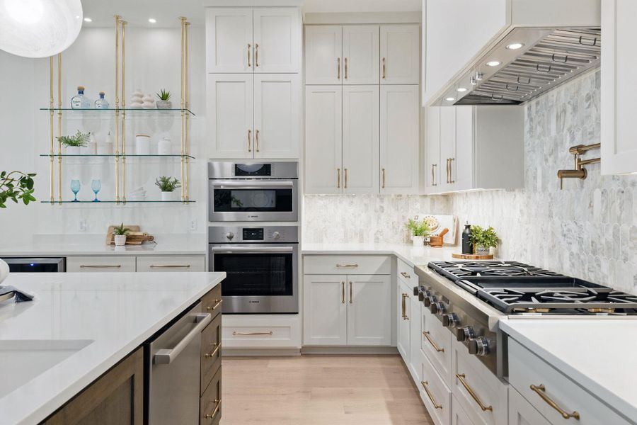 Kitchen featuring light countertops, stainless steel appliances, range hood, tasteful backsplash, and recessed lighting