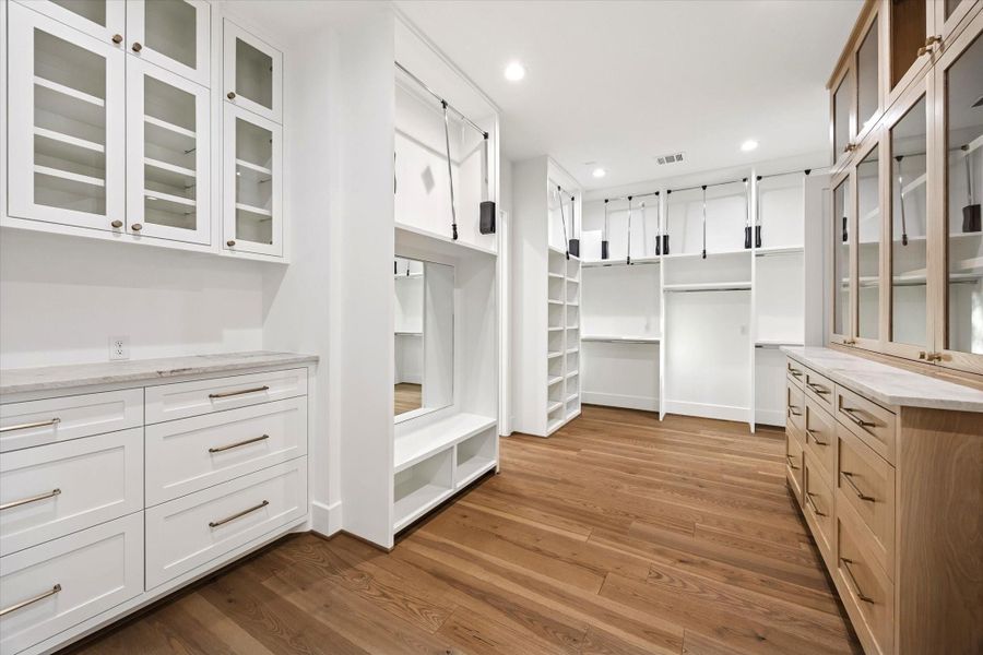 Custom built ins, abundant hanging space, and integrated drawers create a true dressing room experience. Wide circulation paths and a dedicated seating niche support easy organization and everyday use. **Previous build by Arch Angelo** Custom built ins, abundant hanging space, and integrated drawers create a true dressing room experience. Wide circulation paths and a dedicated seating niche support easy organization and everyday use. **Previous build by Arch Angelo**