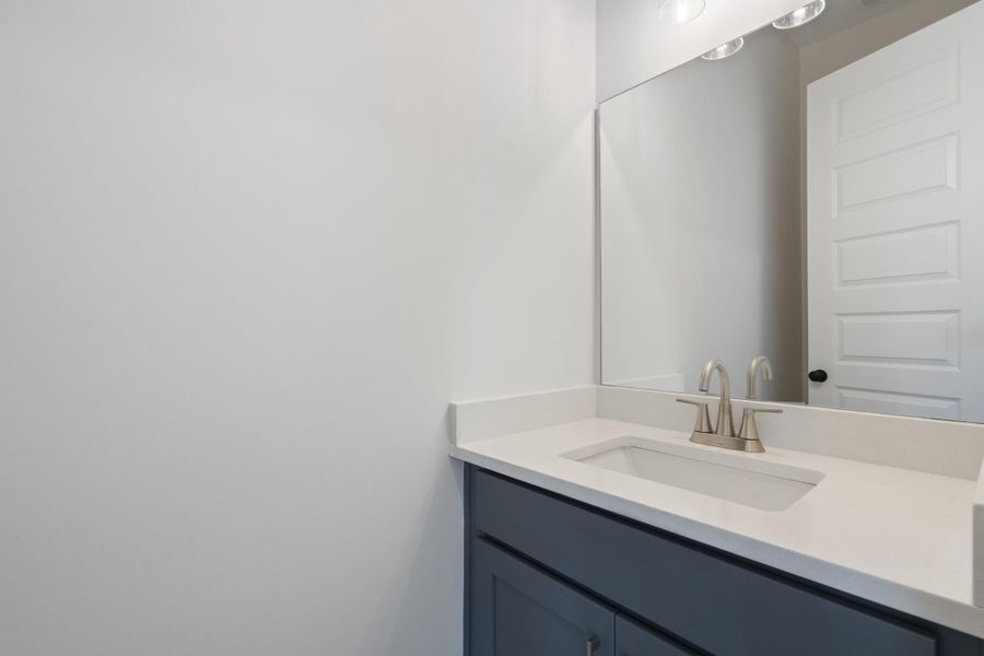 Vanity with a white countertop and an integrated rectangular sink