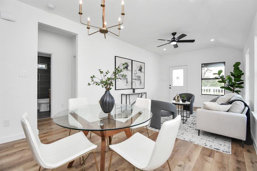 Modern kitchen with white cabinetry, stainless steel appliances, and wood flooring.