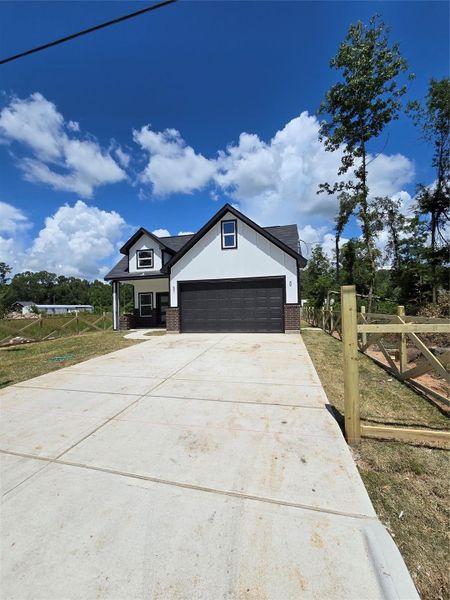Front exterior of a new home in , Splendora, TX, highlighting curb appeal (Image 13).
