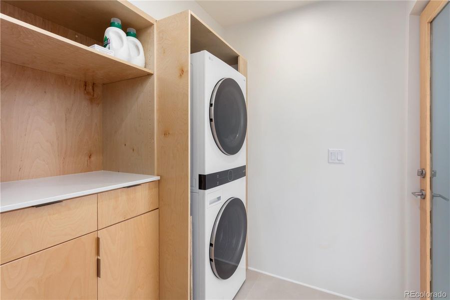 Shared laundry room located between each unit. Accessed from front screened-in porch. This room also provides access to tall crawl space that houses the utility infrastructure that includes separate hot water holding tanks, on demand hot water heater and separate electric meters.