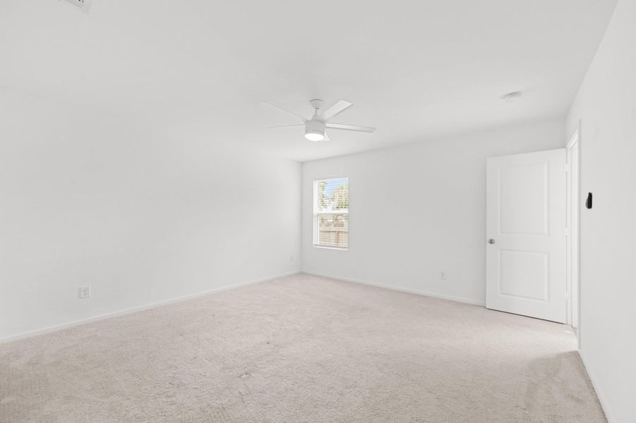 Alternate view showcases the primary bedroom’s generous floor space, clean neutral finishes, and flexible wall space for furniture placement. Alternate view showcases the primary bedroom’s generous floor space, clean neutral finishes, and flexible wall space for furniture placement.