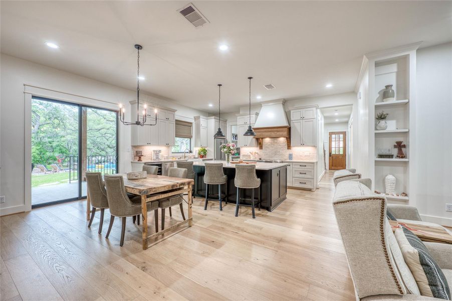Expansive open-concept living area featuring light wood-finish flooring